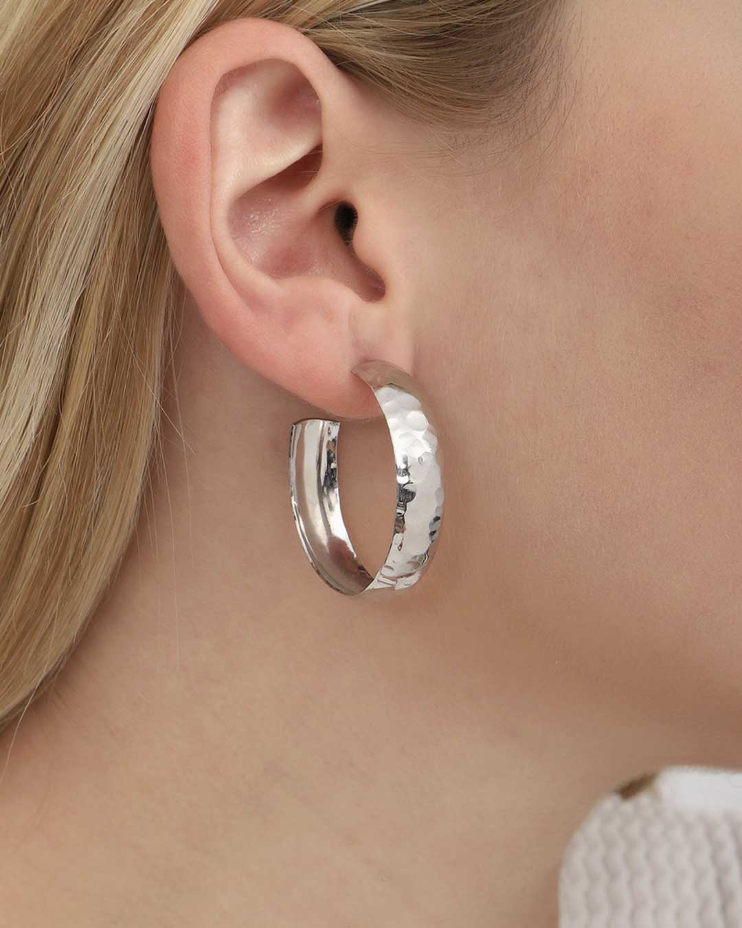 Close-up of textured mixed metal hoop earrings