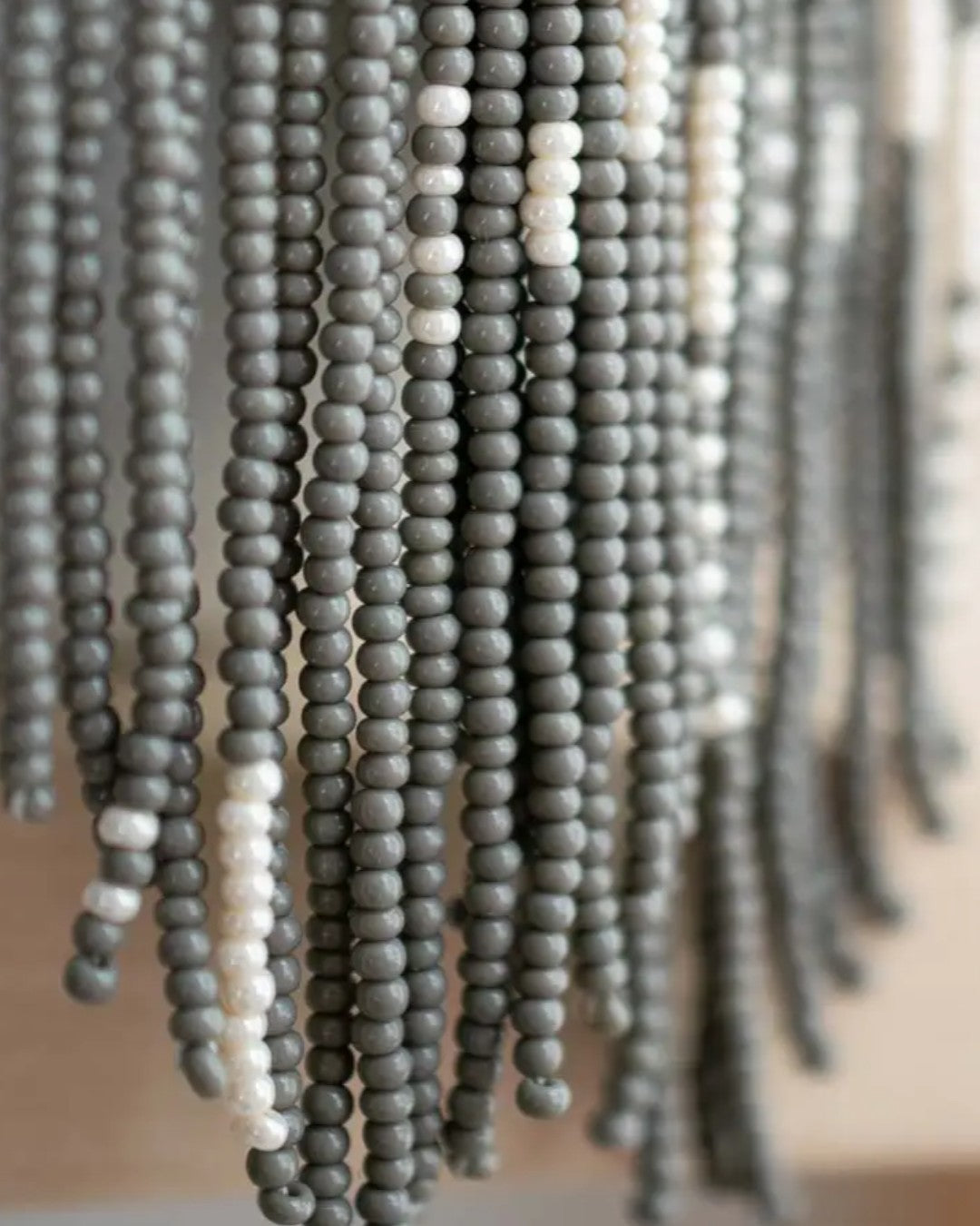 Close-up of gray beaded chandelier with blurred background