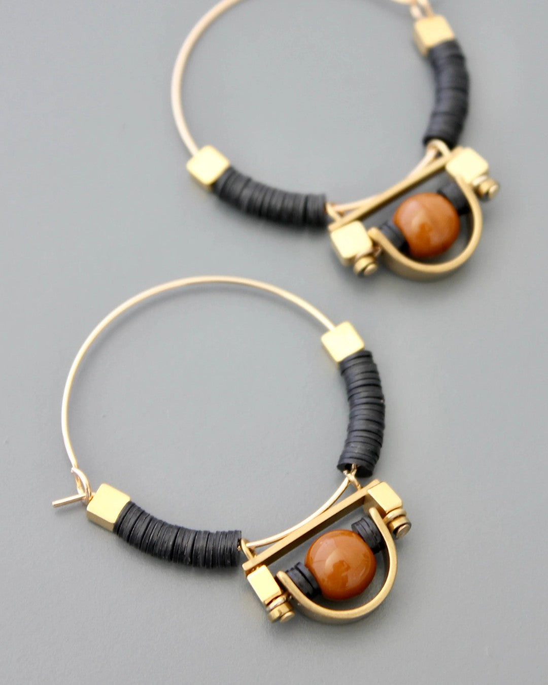 Tribal-inspired earrings with black and gold contrast