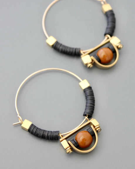 Tribal-inspired earrings with black and gold contrast