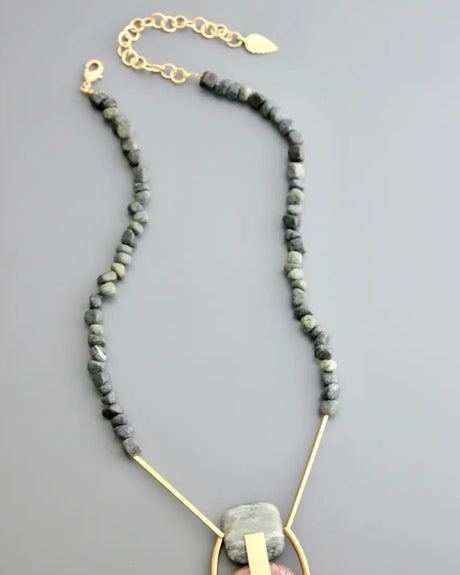Pendant necklace with brass frame and natural stone beads