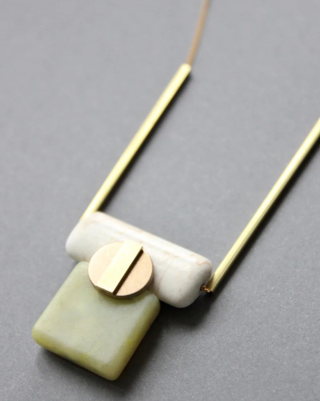 Modern pendant necklace with serpentine, magnesite, and brass