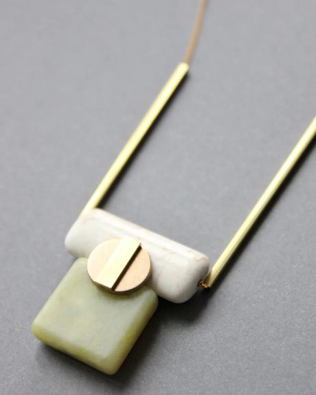 Modern pendant necklace with serpentine, magnesite, and brass