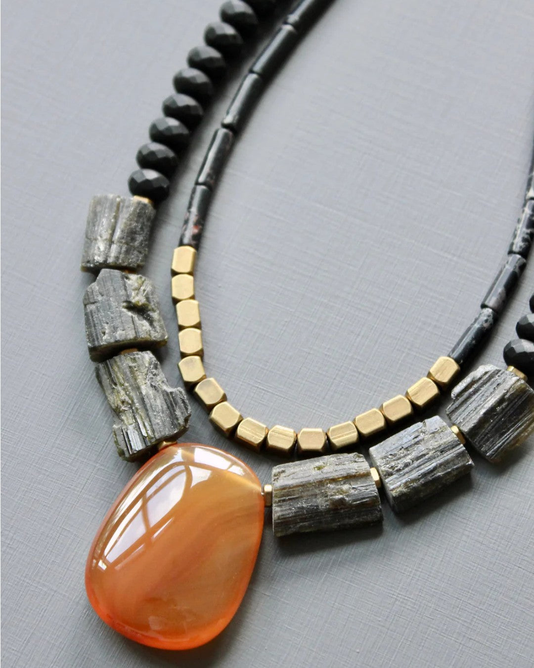 Bold mixed-material necklace with warm and dark tones