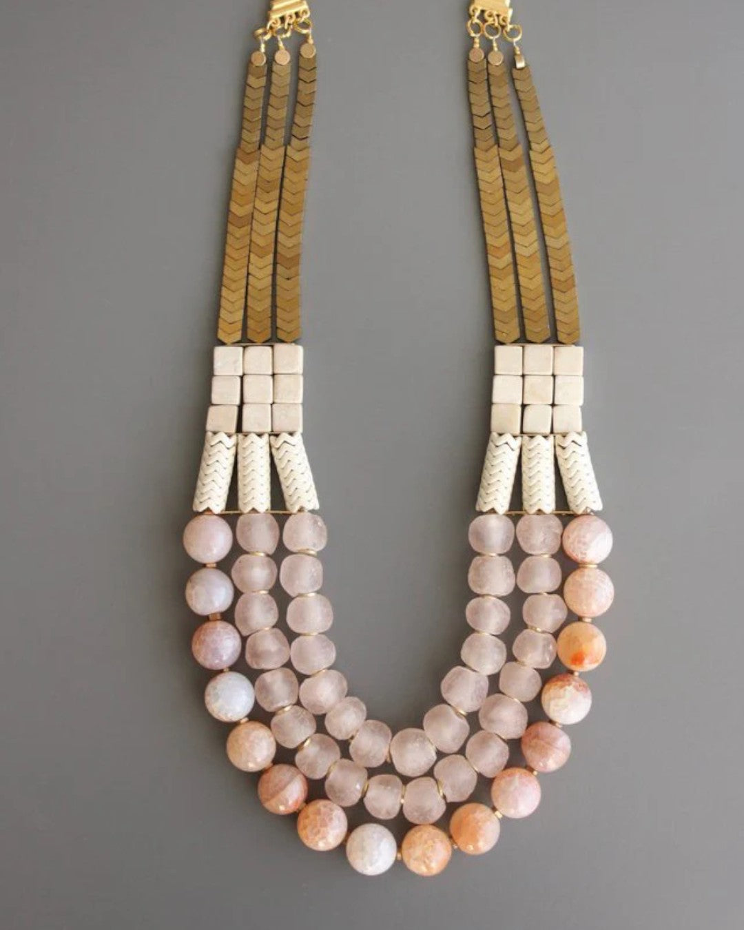 Triple strand fire agate necklace with magnesite and brass