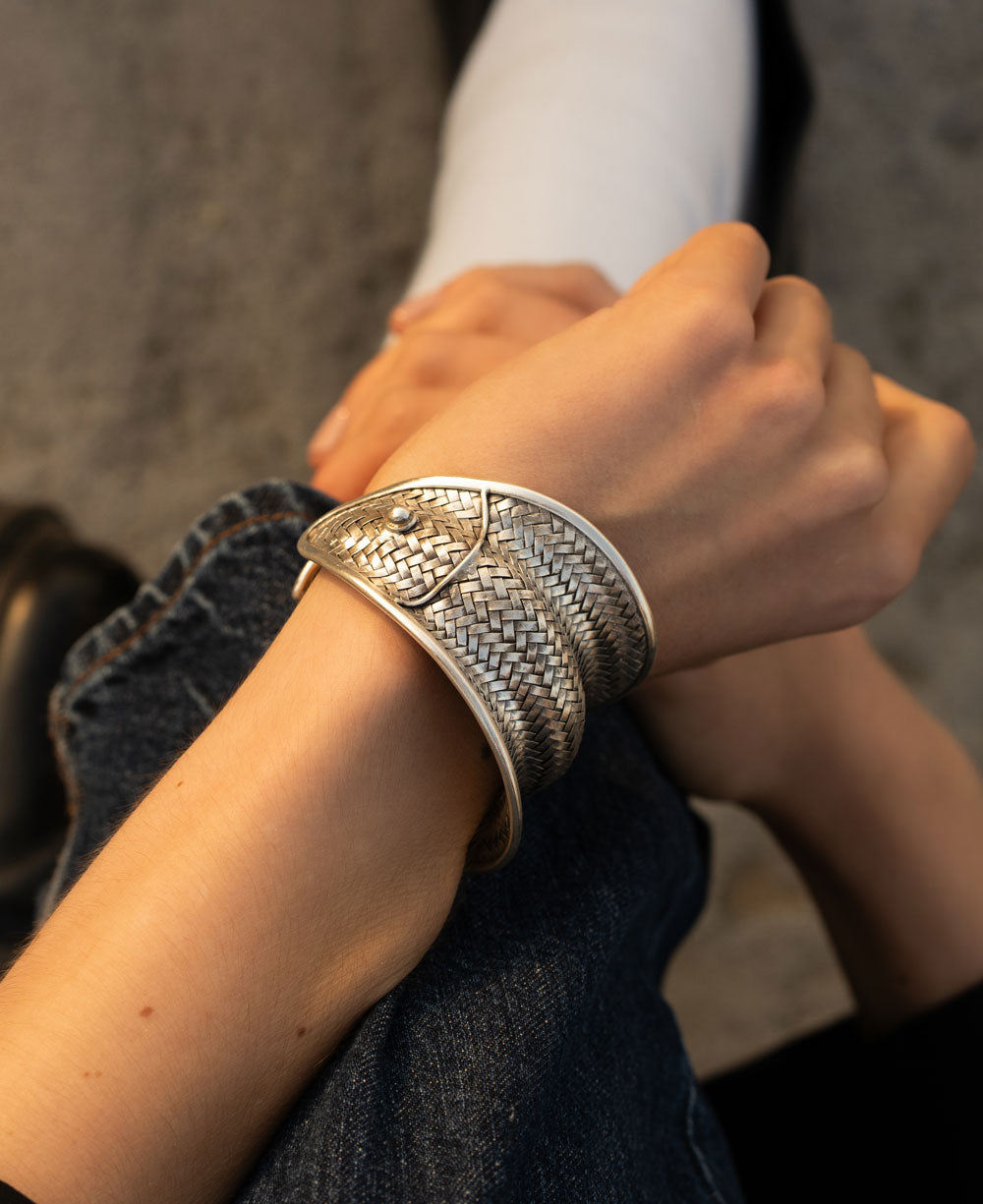 Women wearing a hilltribe silver jewelry bracelet in a fish design in Chicago