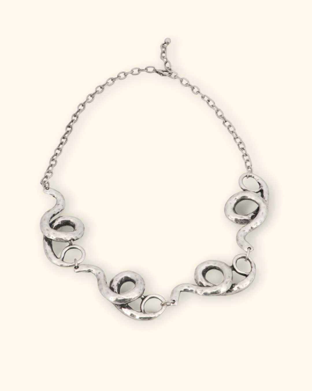 Silver spiral link necklace with hammered texture and flowing design