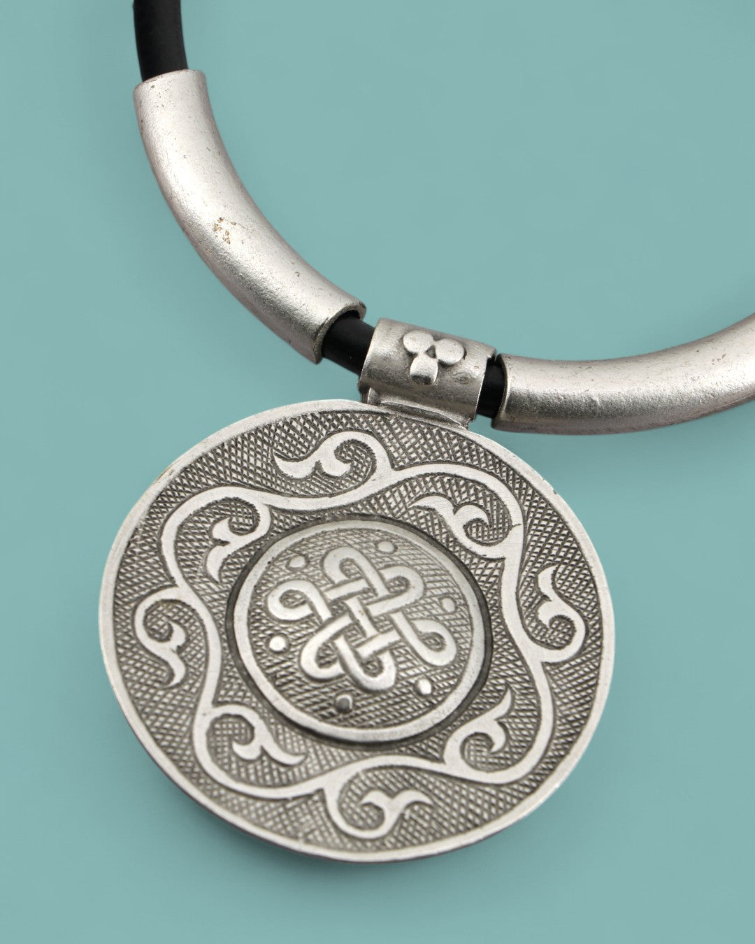 Bold pendant necklace featuring eternal knot symbol