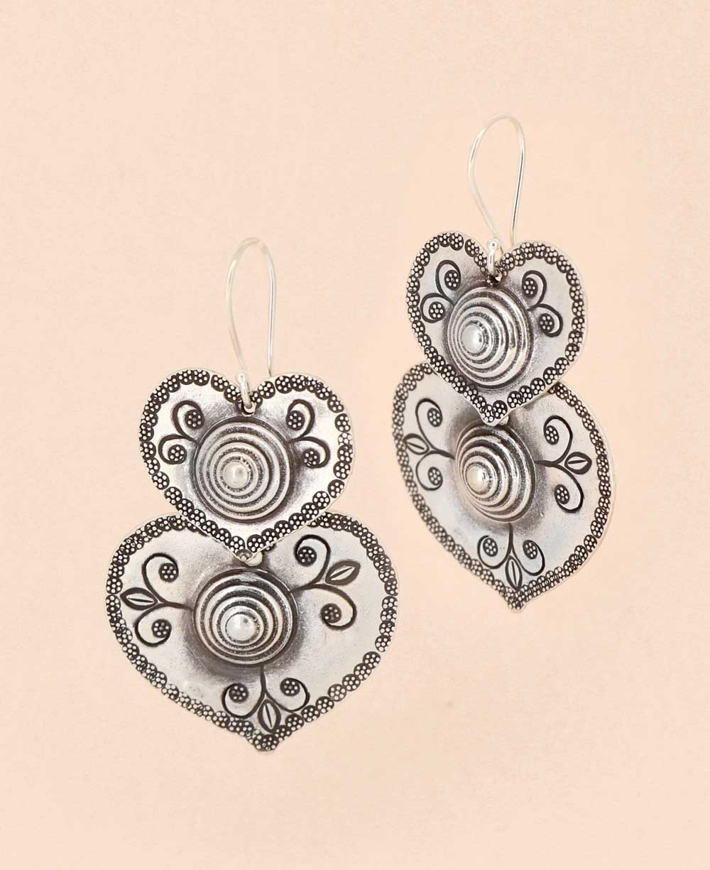 Elegant silver double-heart cascade earrings with intricate floral engravings, handcrafted by Laotian artisans