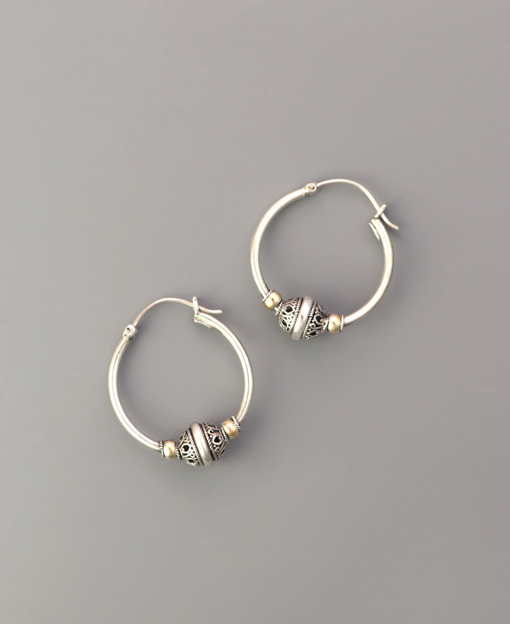 Sterling silver hoop earrings with gold details