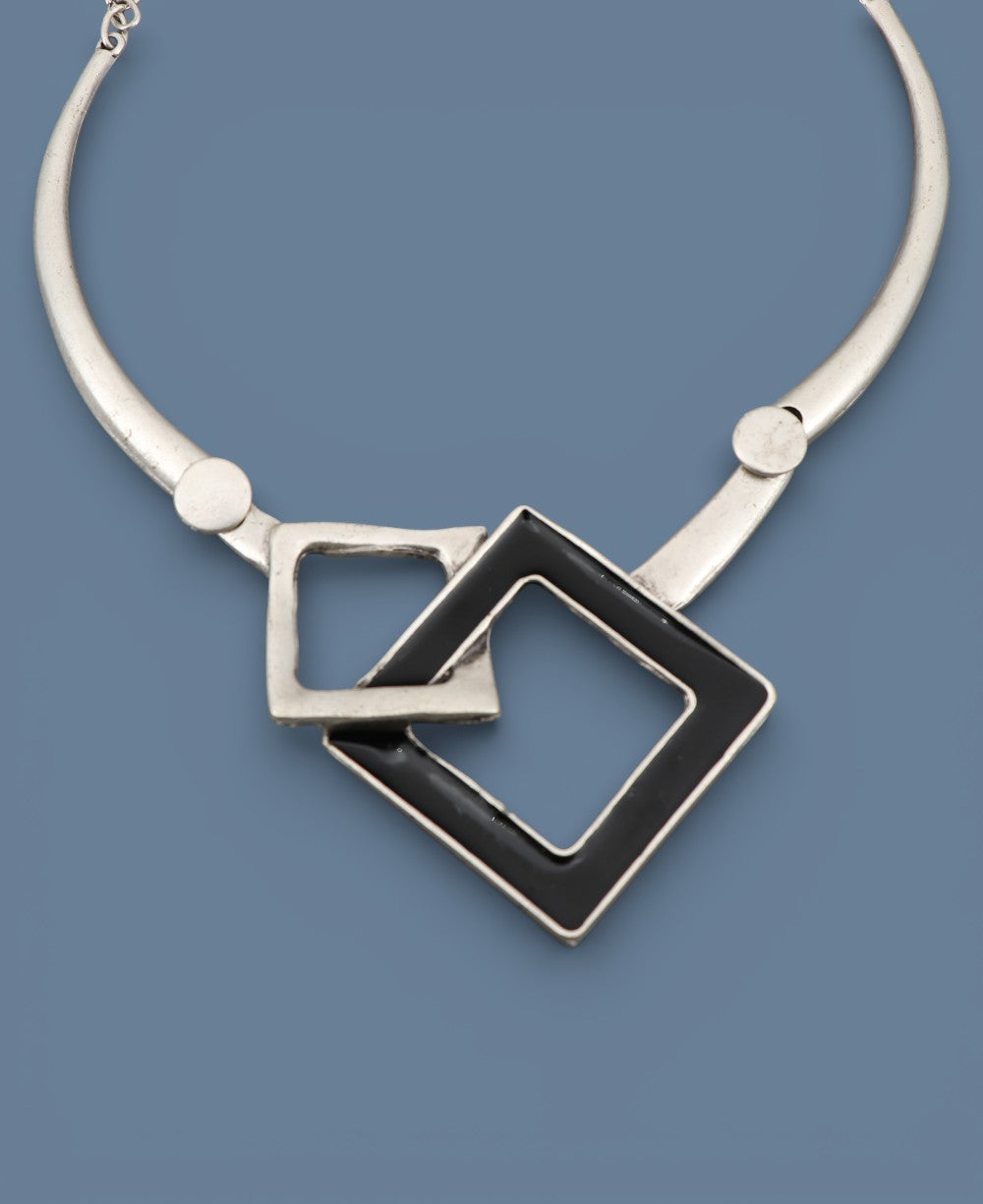 Necklace with square pendants on a blue background