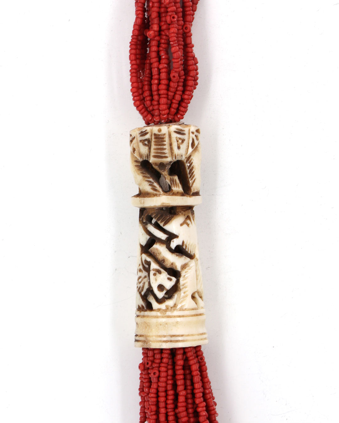 Red beaded necklace with a decorative bone or antler piece on a white background