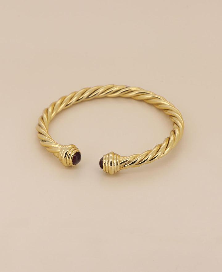 Elegant gold plated brass bracelet, showcasing its adjustable open-ended design and unique twisted rope pattern