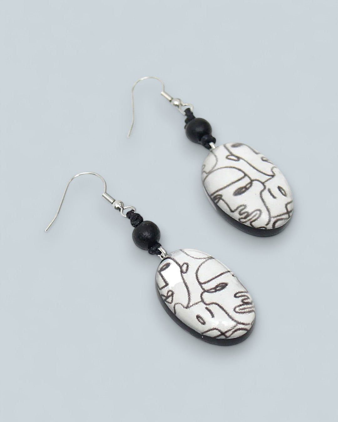 Artistic oval resin earrings with modern abstract face outlines