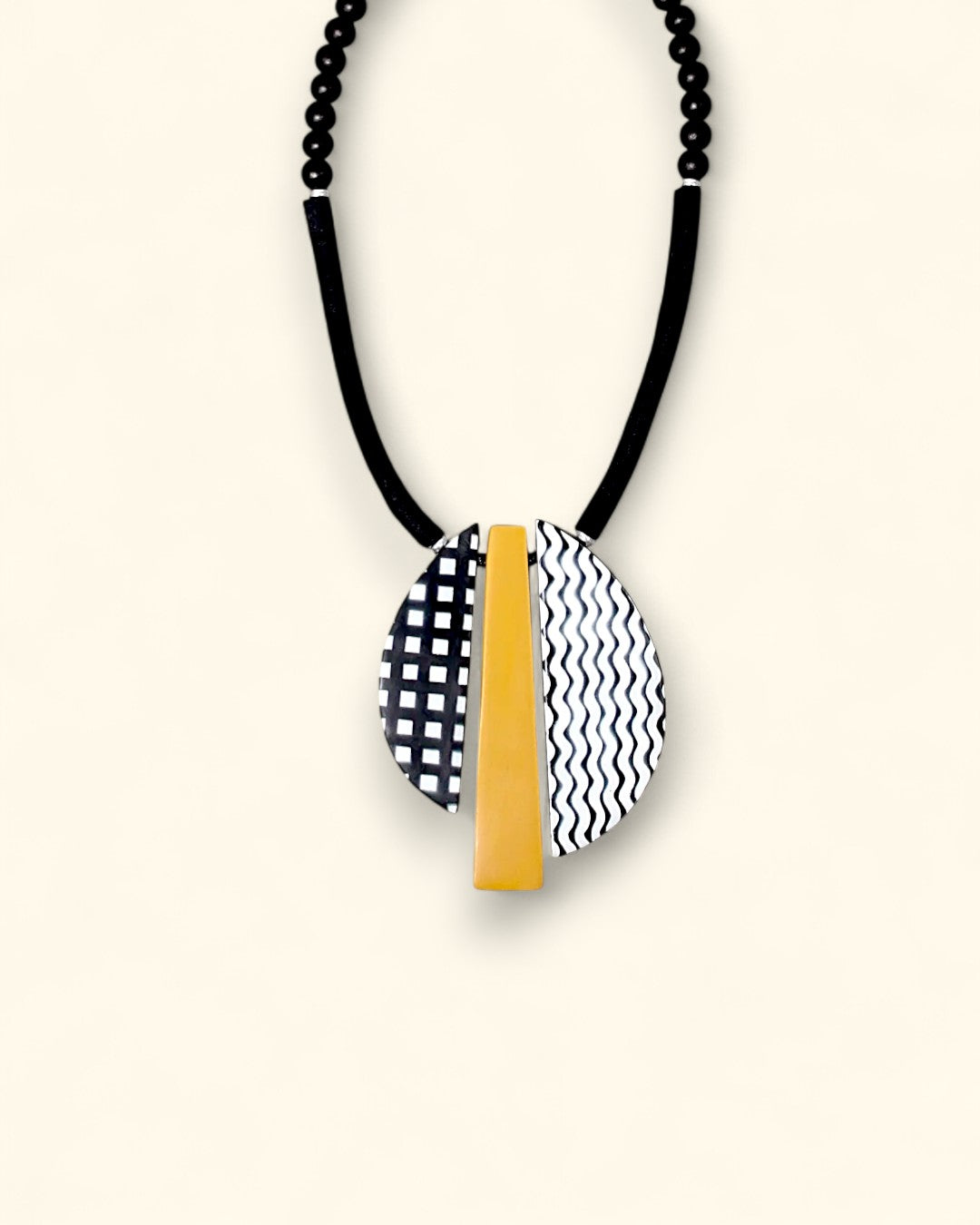 Black, white, and mustard geometric resin pendant necklace