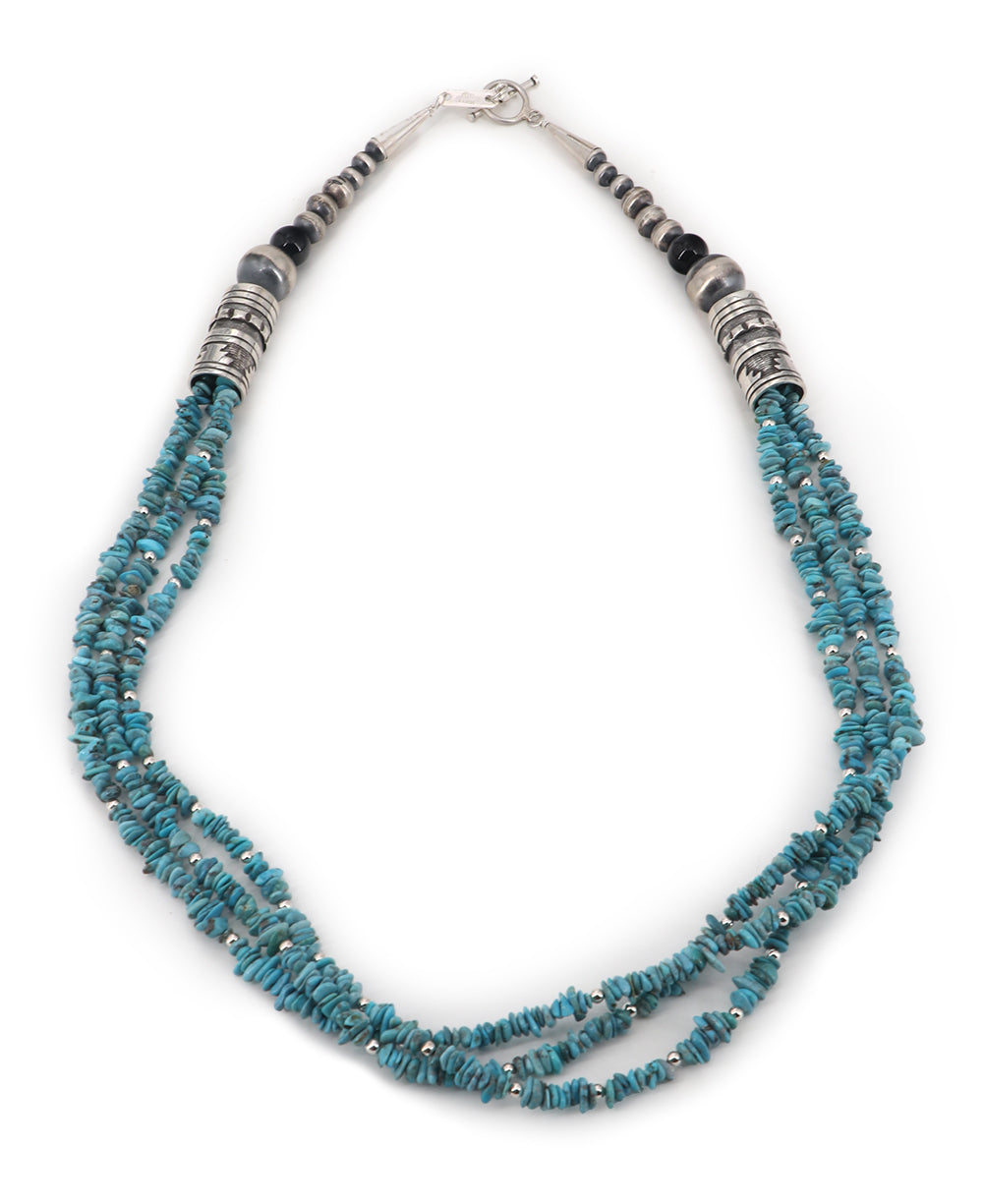 Triple-strand turquoise chip and sterling silver bead necklace showcasing a tribal-inspired designTriple-strand turquoise chip and sterling silver bead necklace showcasing a tribal-inspired design