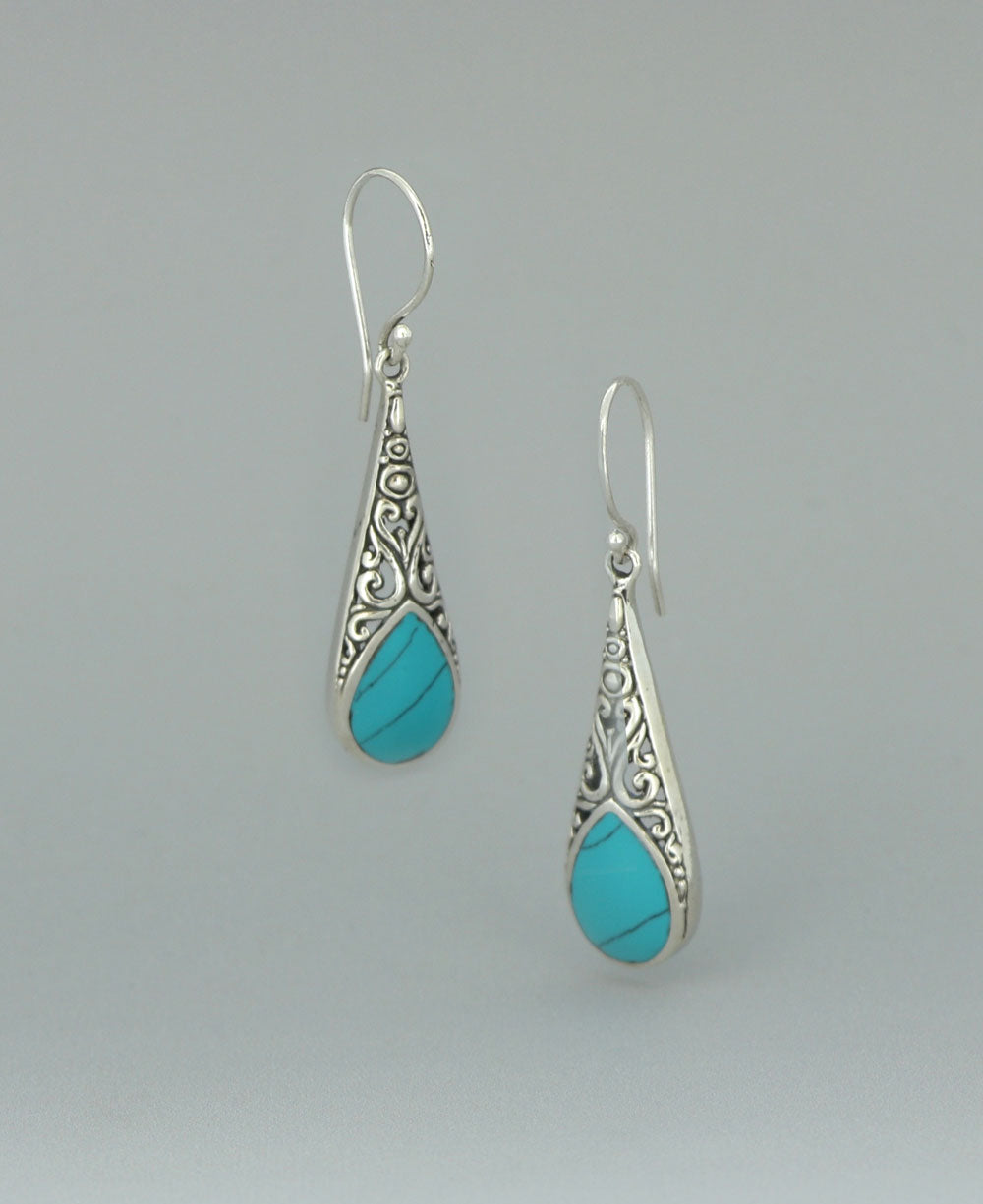 Full view of the sterling silver Reconstituted Turquoise earrings against a light background, showcasing the intricate filigree work and vibrant turquoise inlay