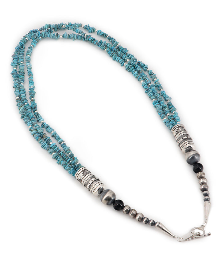 Handcrafted tribal necklace made in the USA, featuring strands of genuine turquoise chips and sterling silver beadsClose-up of the sterling silver barrel clasp and turquoise chips in vibrant shades of blue-green