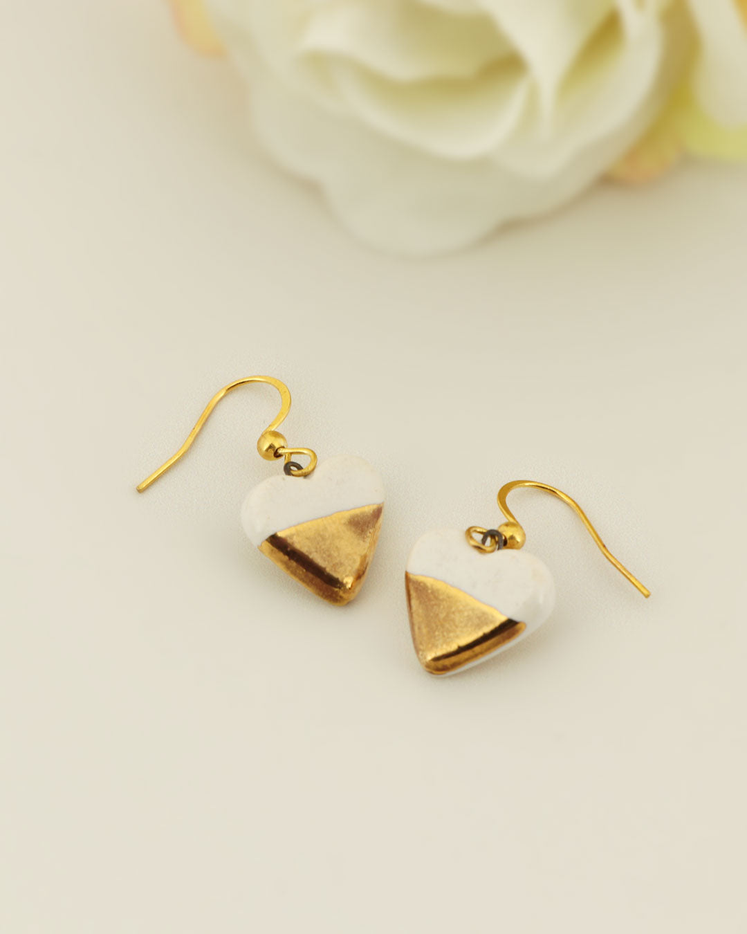 Tiny handmade ceramic heart earrings in gold and ivory