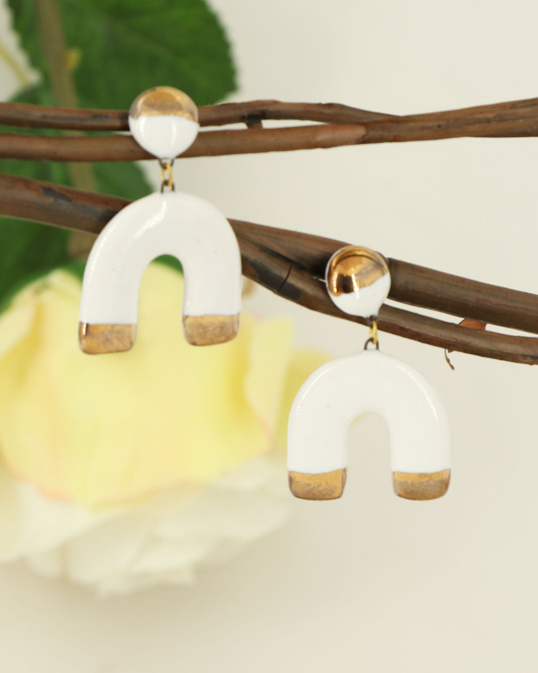 Fair trade ceramic horseshoe earrings with gold accents