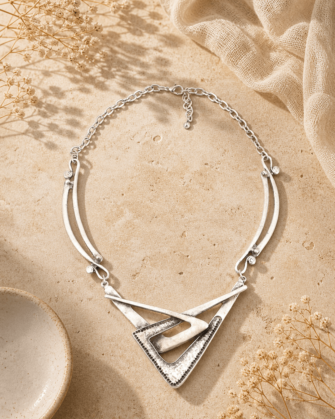 Bold Geometry: Sculptural Alloy Statement Necklace — necklaces, editorial travertine lifestyle photo
