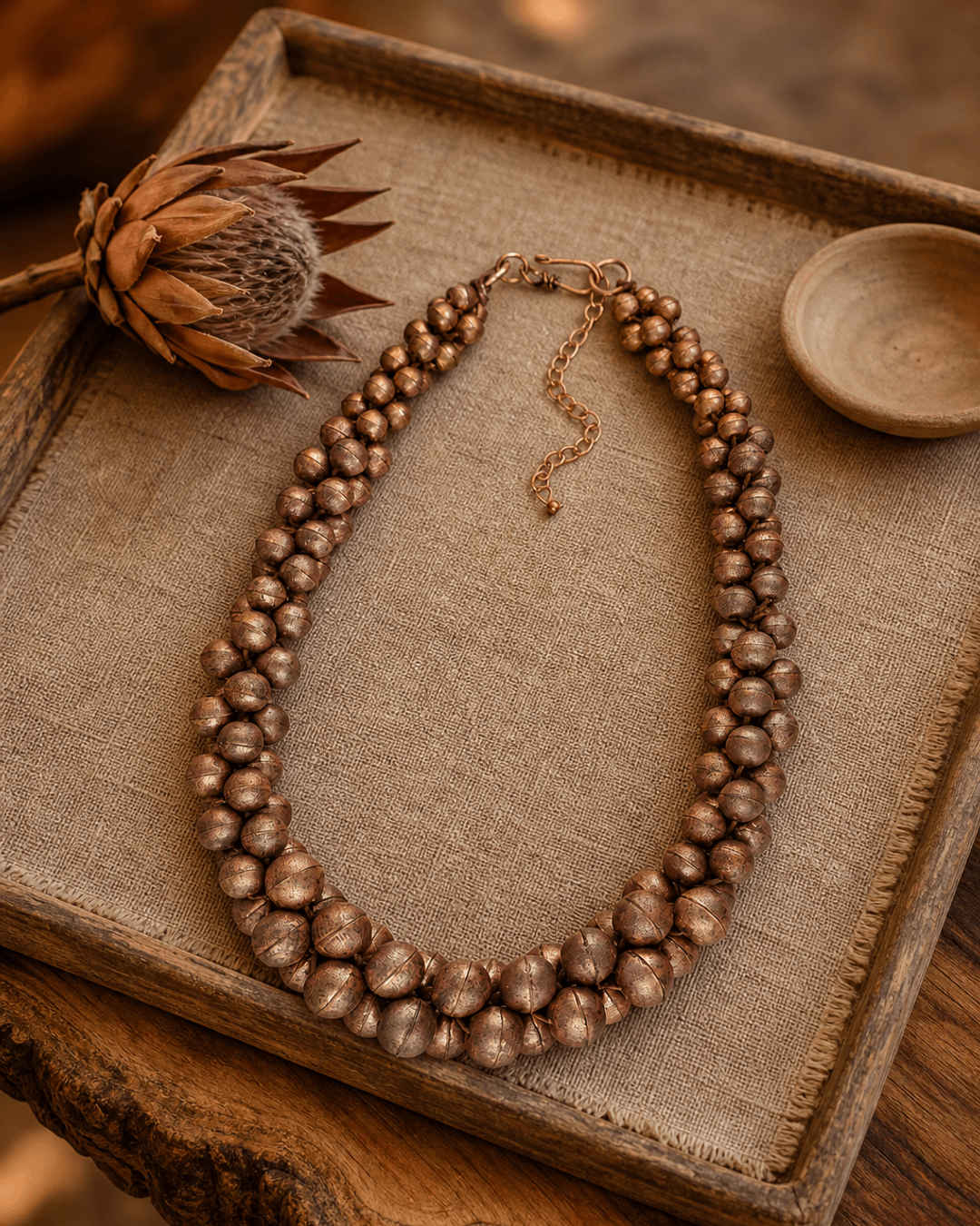 Copper-Tone Layered Statement Necklace — necklaces, vibey macro bokeh linen tray lifestyle photo