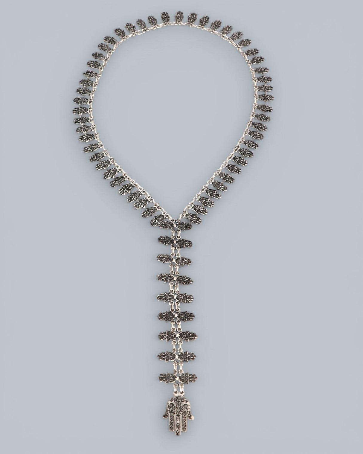 Cultural Elements antique silver tone lariat necklace with ornate Hamsa pendant and repeating links. 26" long.
