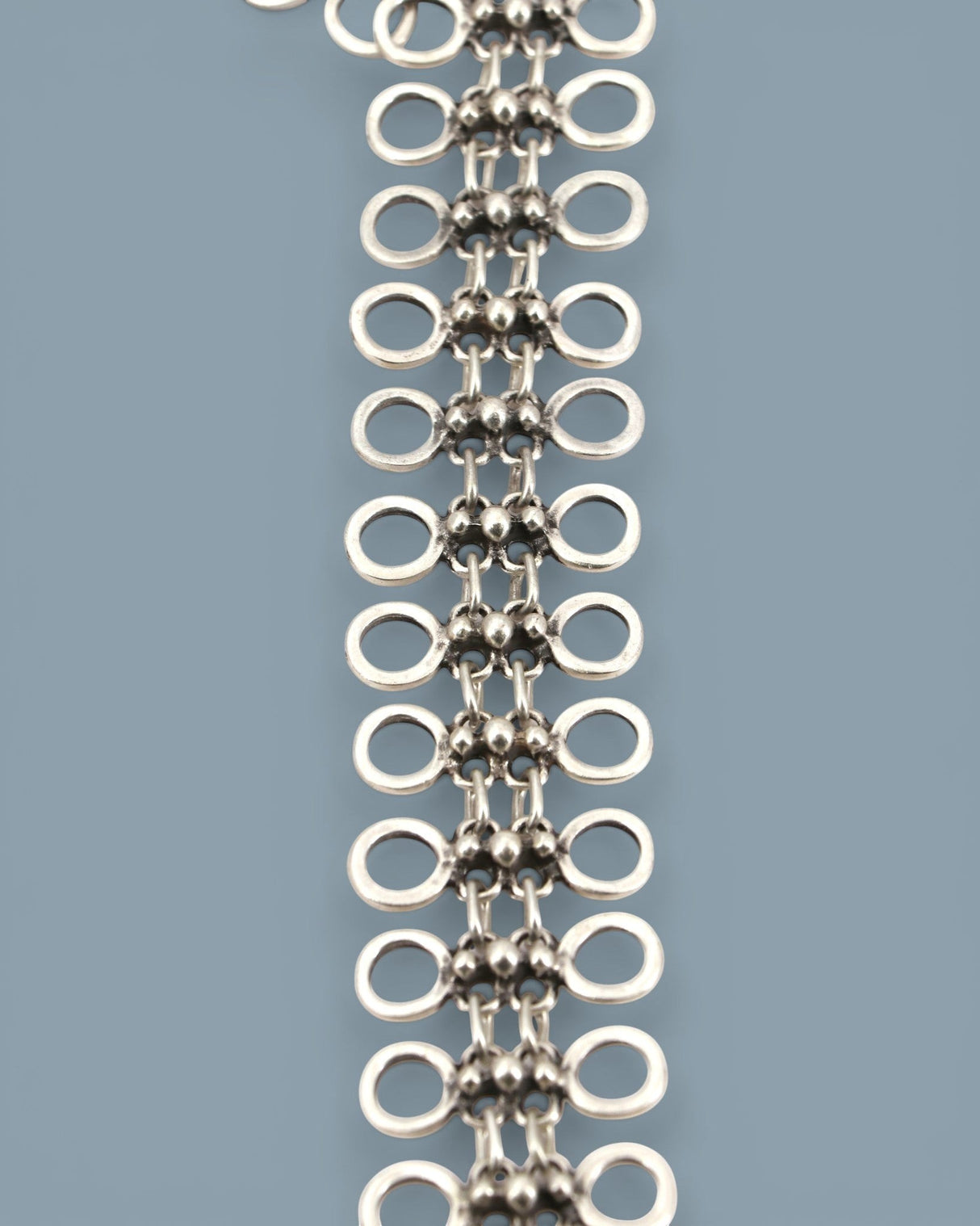 Cultural Elements silver-tone metal alloy lariat necklace with cutout discs and bead-like connectors. Modern Y-shaped silhouette.