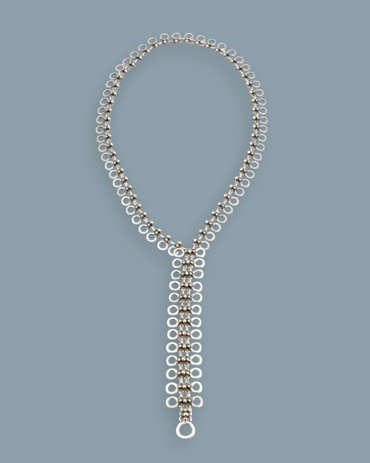 Cultural Elements silver-tone metal alloy lariat necklace with cutout discs and Y-shaped silhouette.