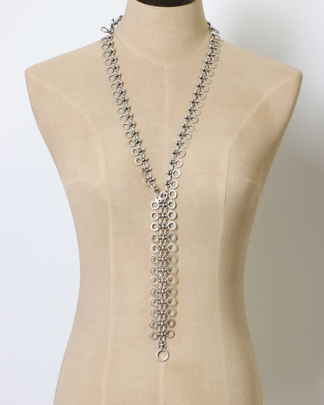 Cultural Elements silver-tone metal alloy lariat necklace with cutout discs and Y-shaped silhouette.