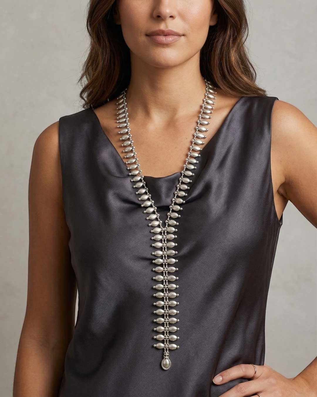 Cultural Elements silver metal lariat necklace with oval and marquise-shaped links, 26" long.