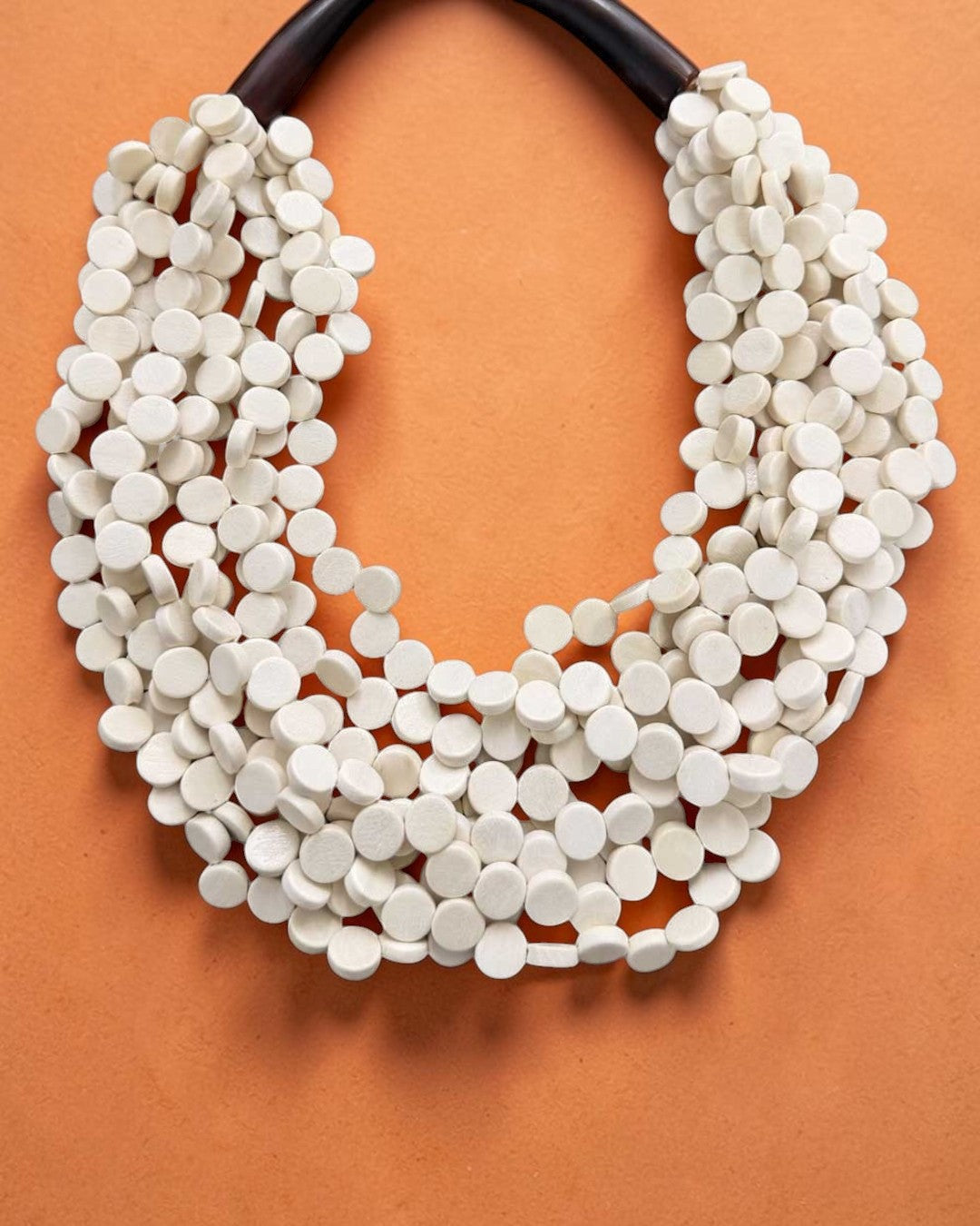 Cultural Elements soft white wood disc necklace with horn closure, 20 inches long, handmade in the Philippines.