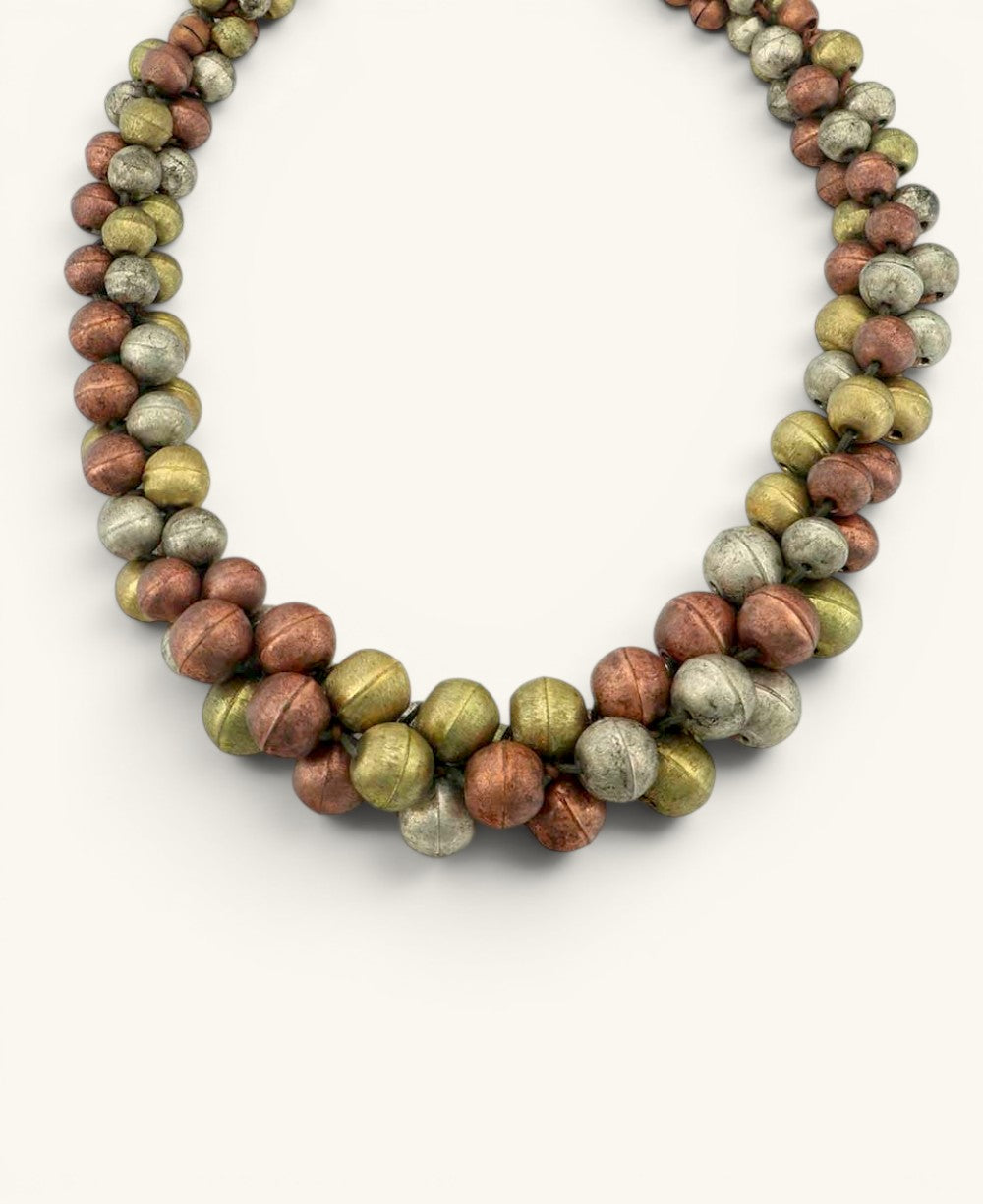 Cultural Elements mixed-tone layered statement necklace with copper, gold, and silver beads. Rustic artisanal finish.