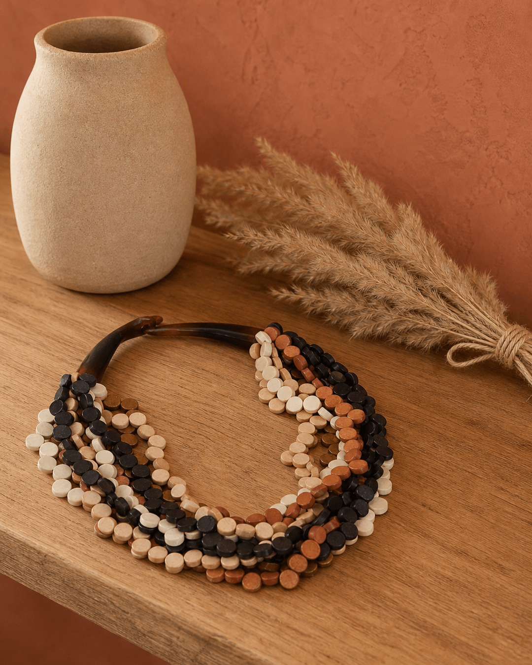 Handcrafted twist wood pendant necklace in earthy brown tones displayed on a lifestyle shelf