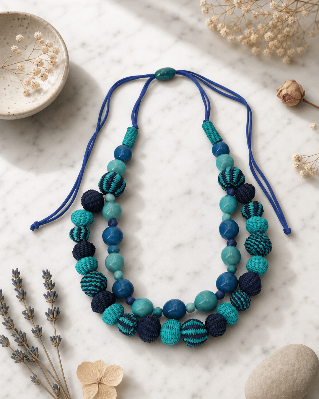 Fair Trade Acai Beads and Iraca Hand-woven Sea Tones Necklace, Colombia — necklaces, editorial marble lifestyle photo