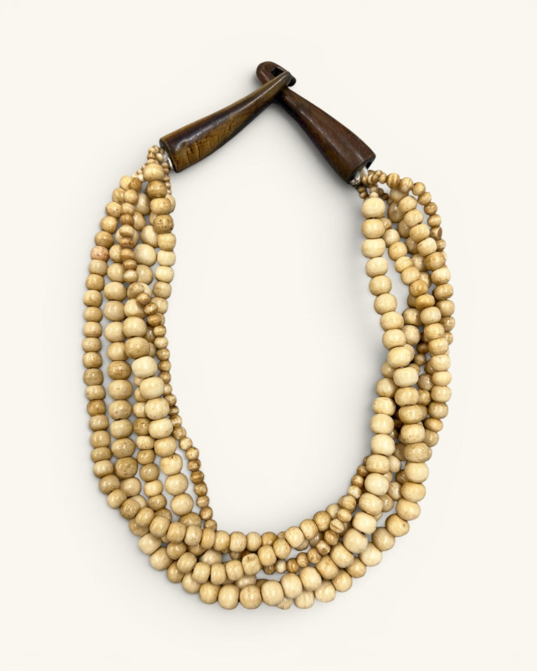 Five-strand Indian bone bead necklace laid flat on white background, horn hook closure fastened at top, front view