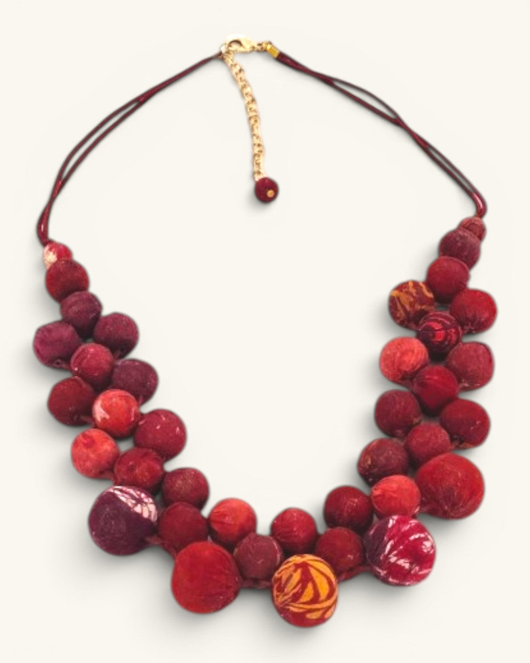 Kantha recycled textile layered bead necklace in red, close detail view showing mixed fabric bead textures and patterned accent beads