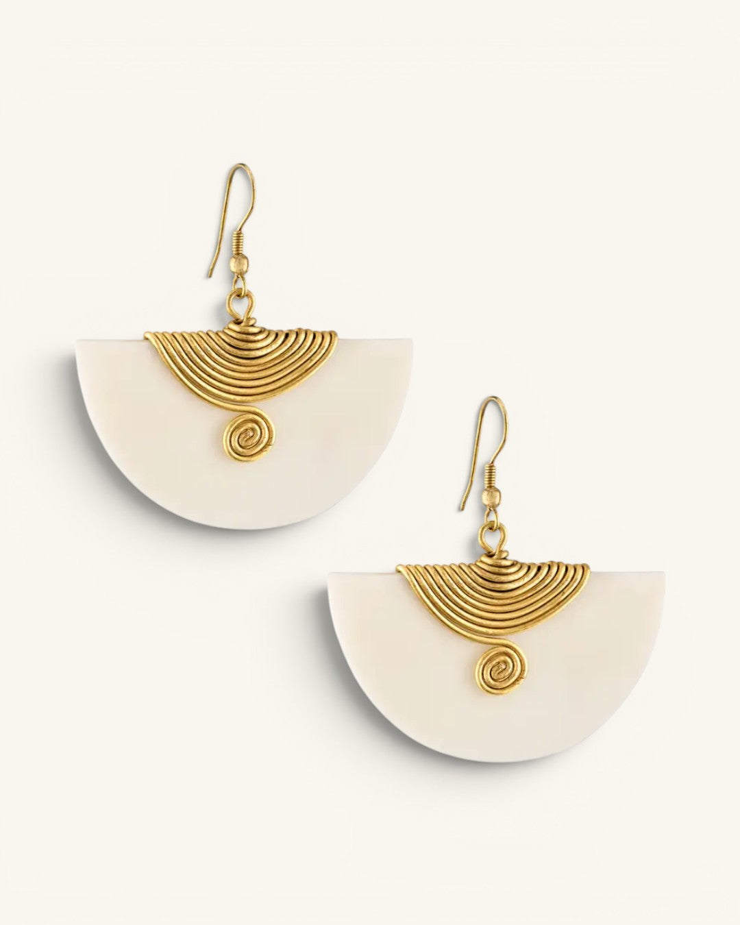 Kenyan hand-carved bone and brass half-moon fan earrings, pair shown flat on neutral background with brass spiral wire detail