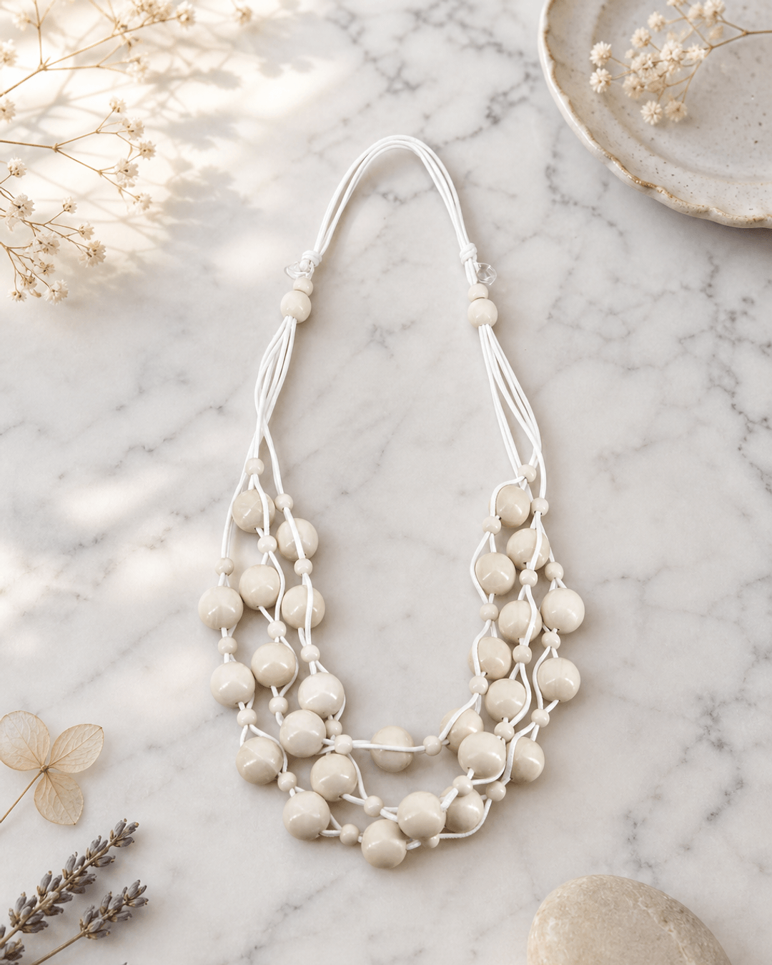 Layered Bead Wood Necklace — necklaces, editorial marble lifestyle photo