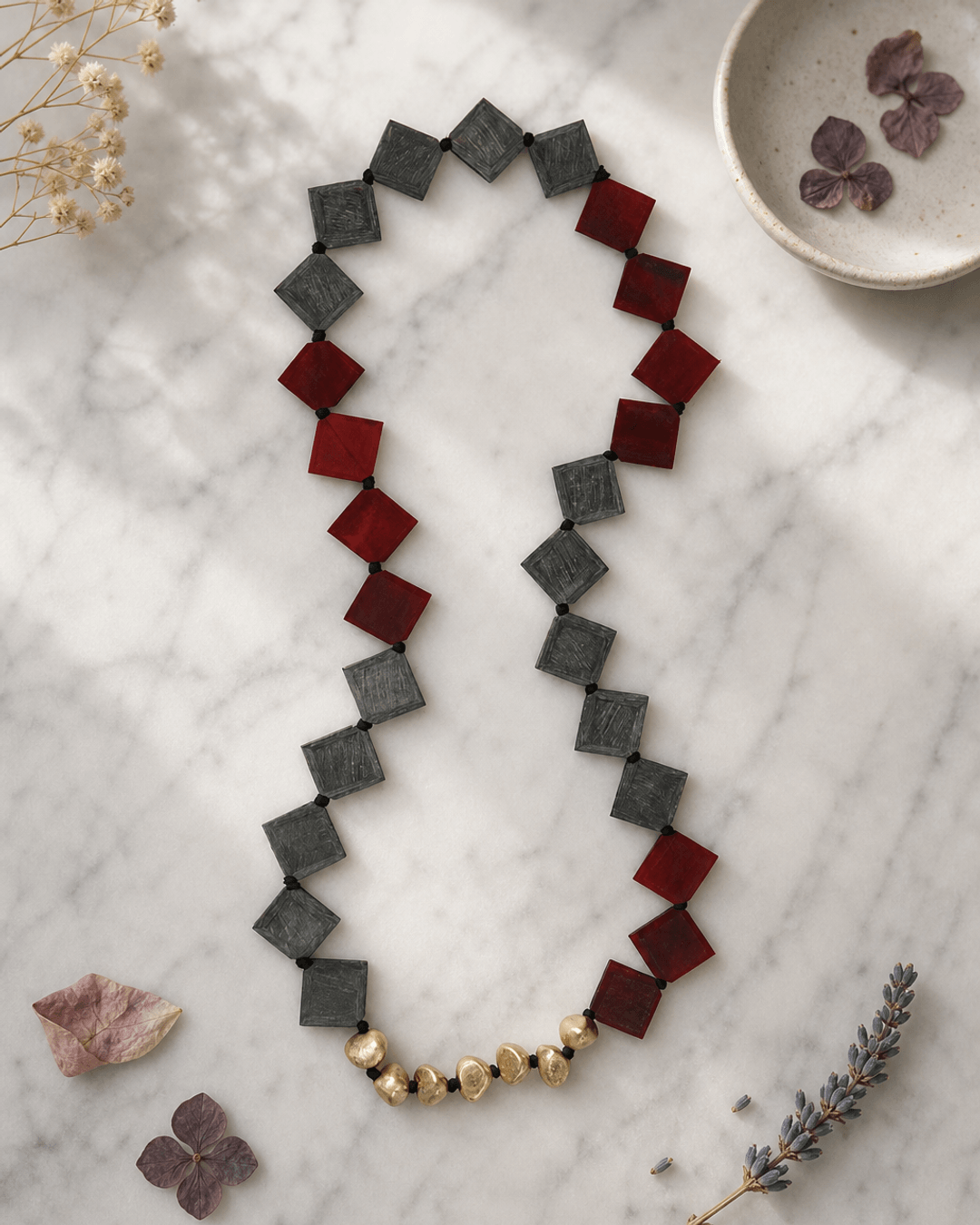 Long Red and Gray Square Horn Necklace with Brass Accents — necklaces, editorial marble lifestyle photo