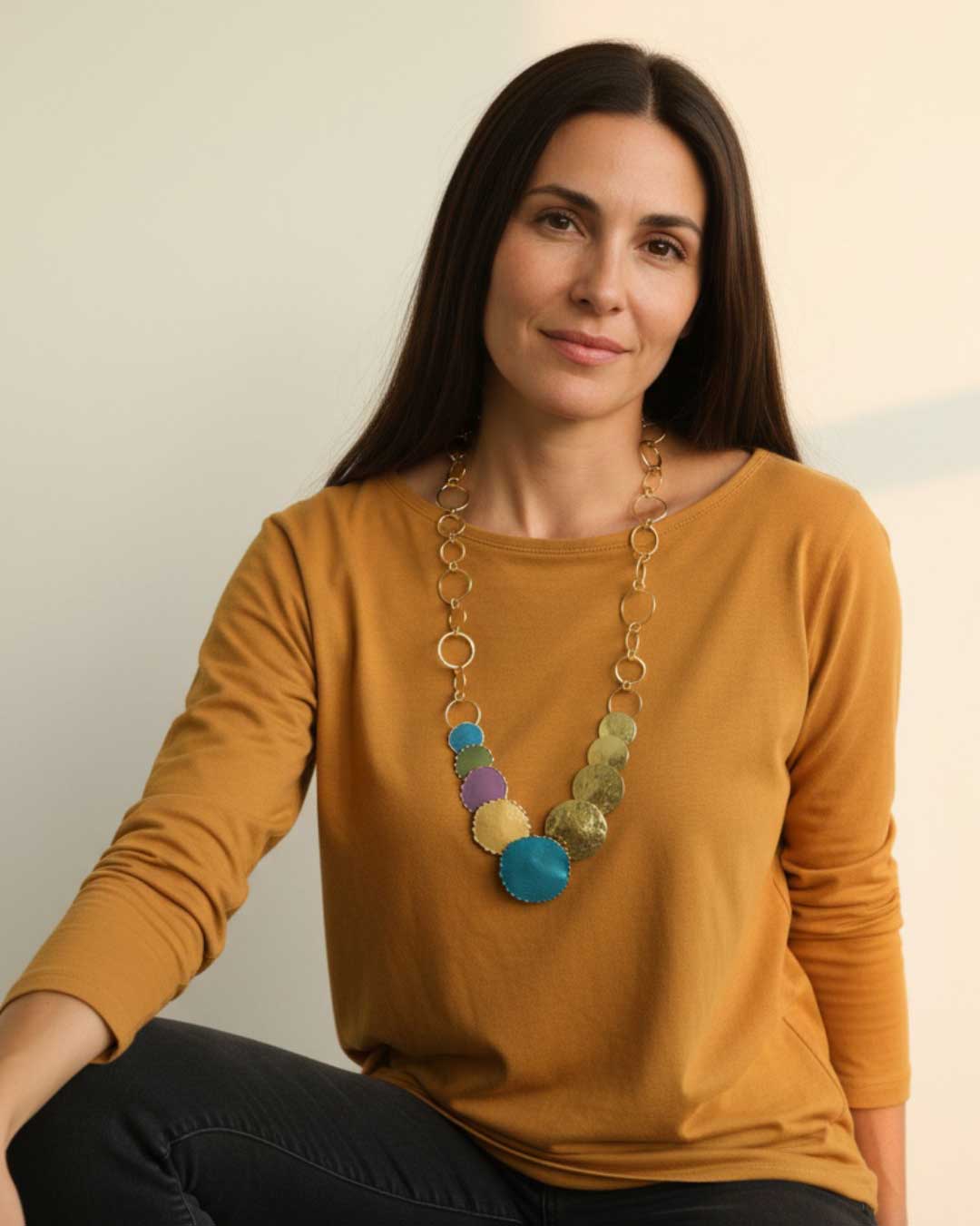 Patina brass disc cascade necklace worn on neck, showing how the layered brass discs fall against the collarbone