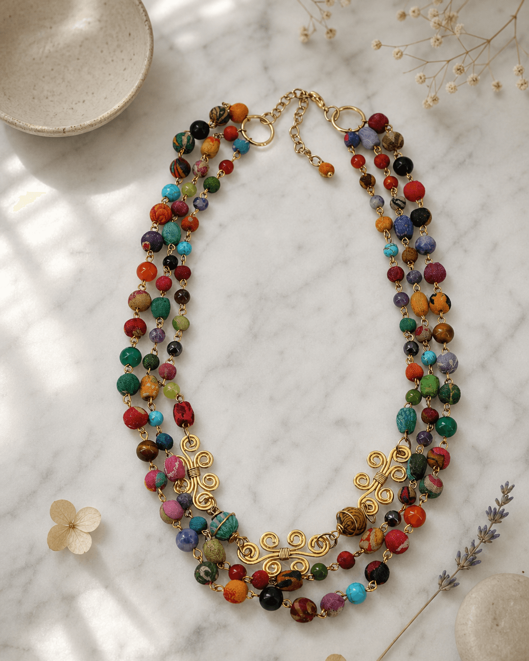 Spiral Brass Kantha Gemstone Necklace — necklaces, editorial marble lifestyle photo