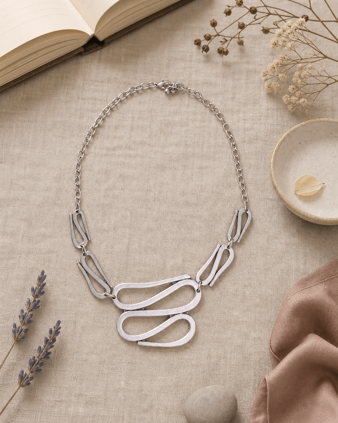 Swirly S-Shaped Statement Necklace — necklaces, flatlay linen lifestyle photo