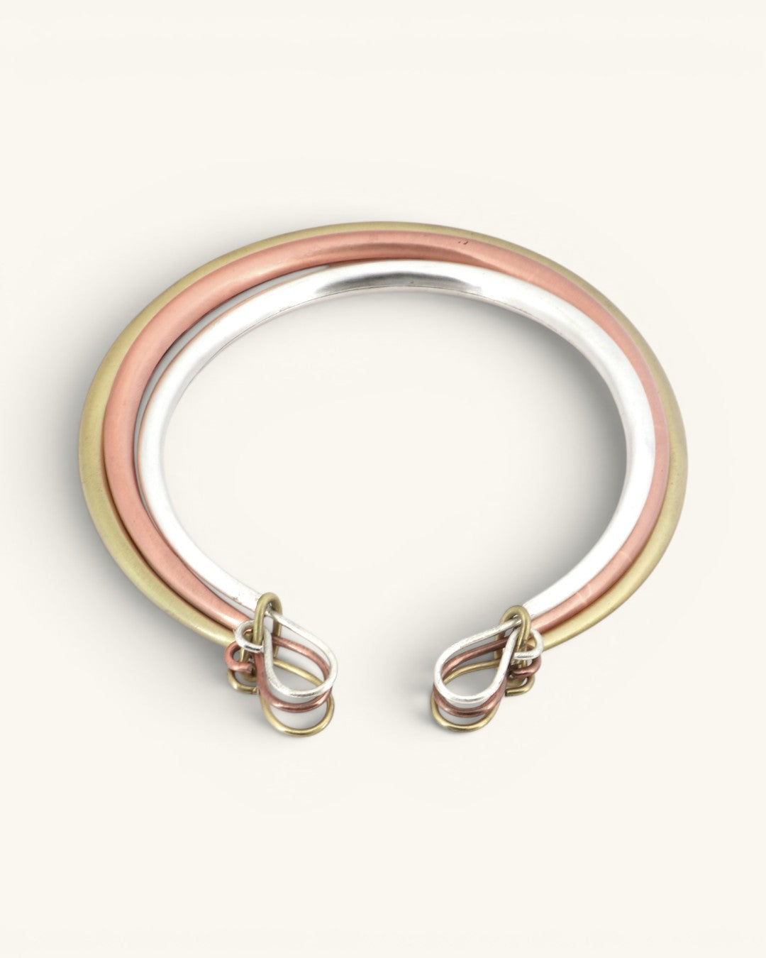 Tri-Tone Brass Collar Necklace back view on white background showing the hook-and-loop clasp hardware in silver, copper, and brass tones