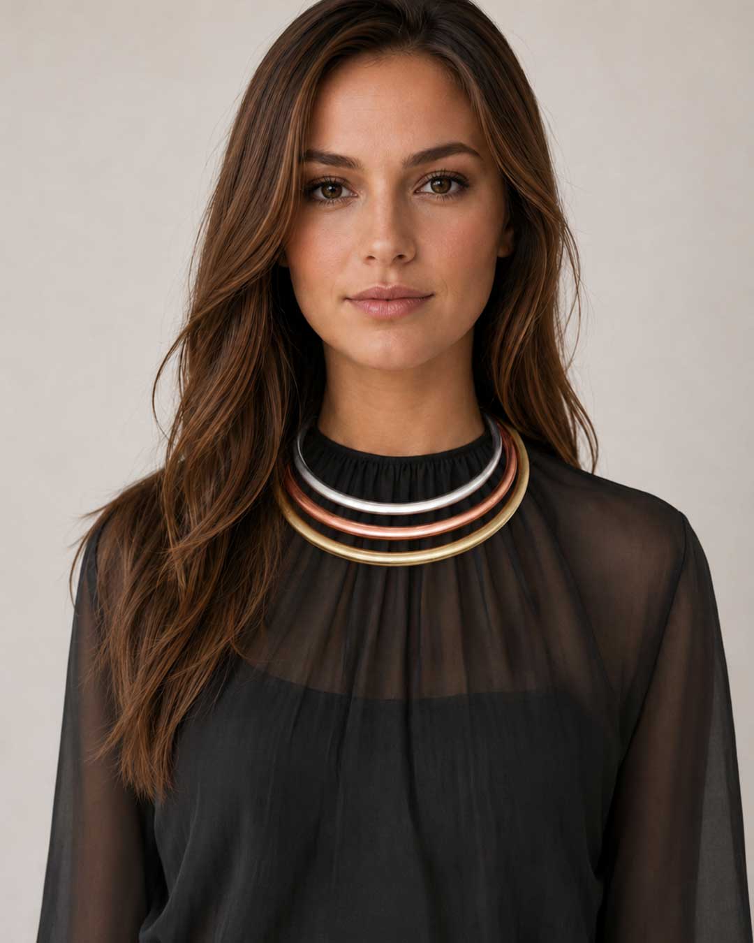 Tri-Tone Brass Collar Necklace worn by a model over a black sheer blouse, silver, copper, and brass bands sitting at the throat