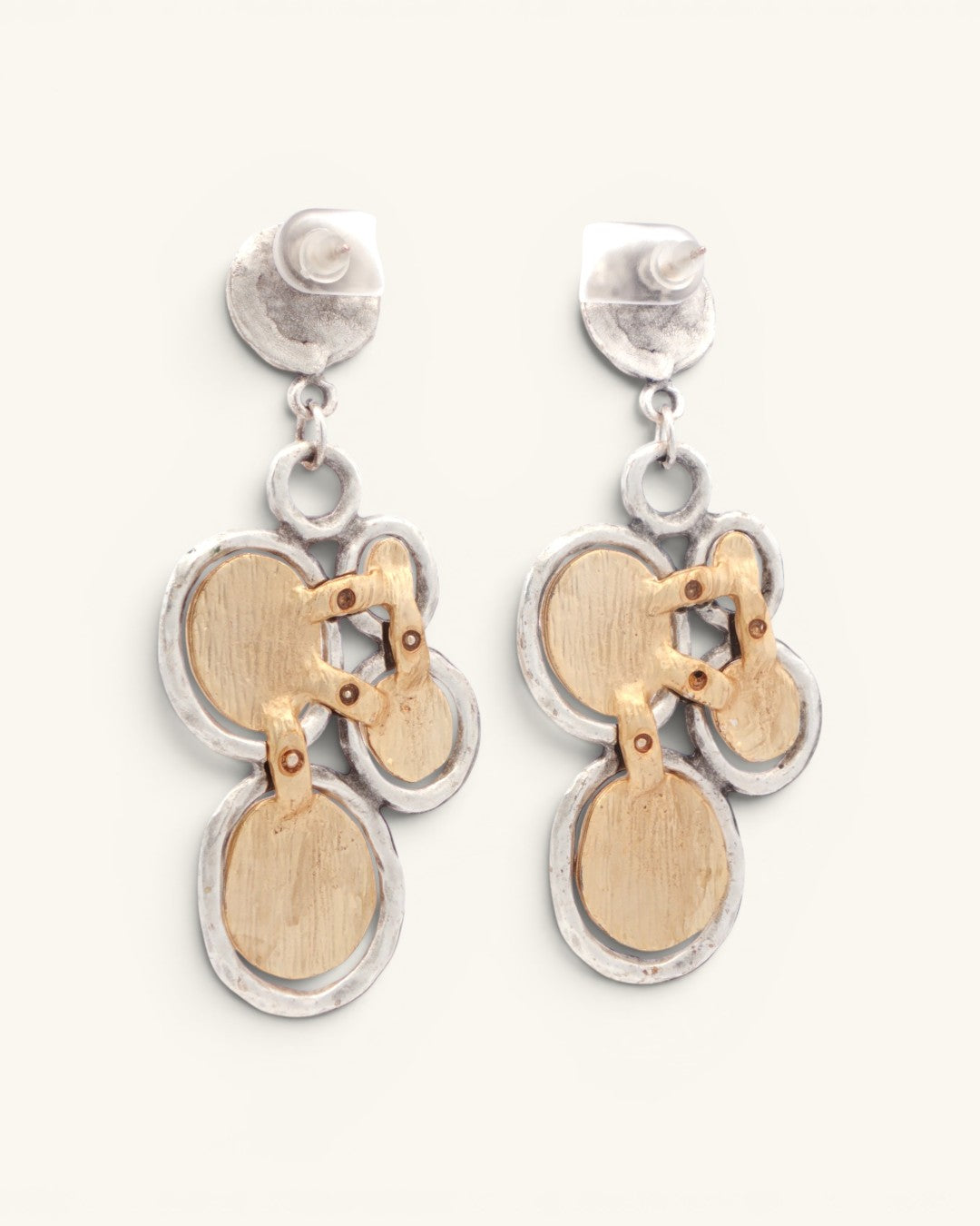 Back view of Turkish two-tone boho dangle earrings revealing gold disc reverse construction and post backs on silver studs