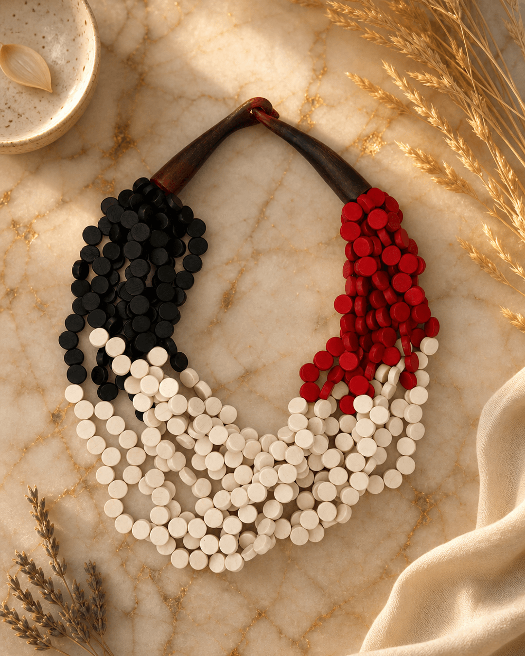 Twisted Multi-Strand Black, Red, and White Necklace — necklaces, editorial marble warm lifestyle photo