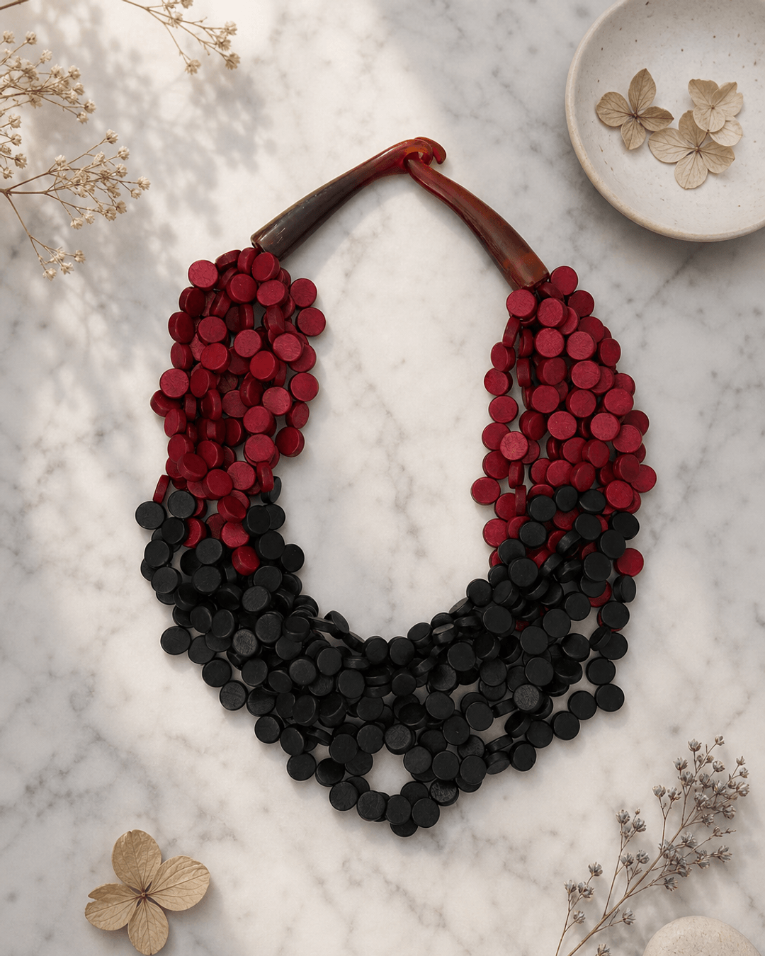 Twisted Multi-Strand Red and Black Necklace — necklaces, editorial marble lifestyle photo