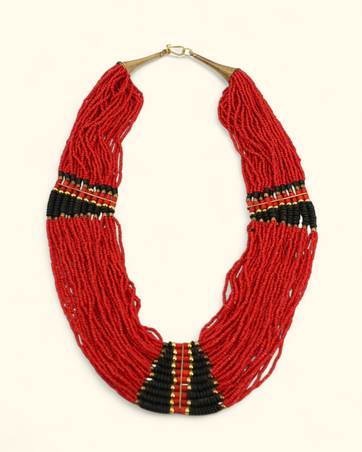 Red beaded necklace with black and gold accents on a white background
