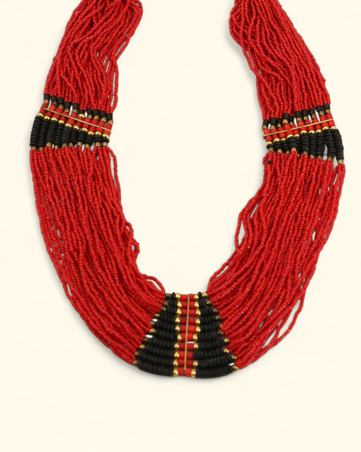 Red beaded necklace with black and gold accents on a white background